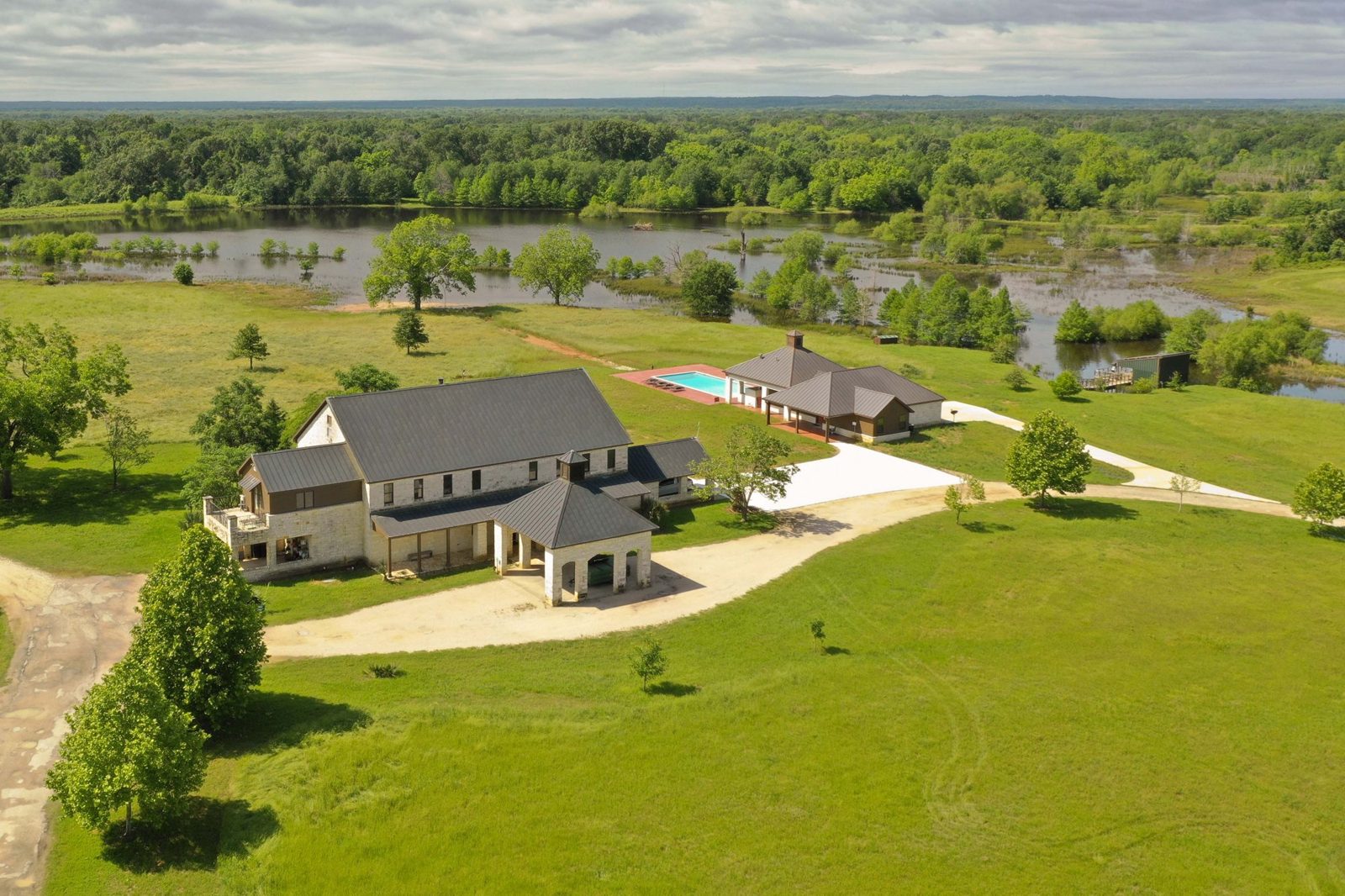 Aerial view of the BigWoods lodge, pool and grounds