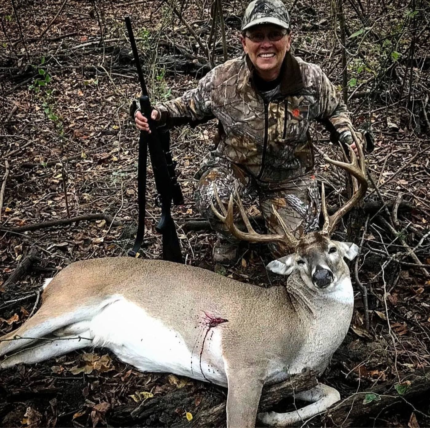 Whitetail hunter with her buck at The BigWoods