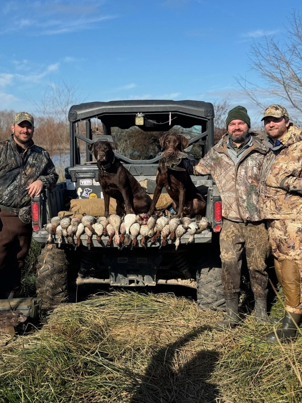Duck hunting guests with retrievers and a harvest at The BigWoods
