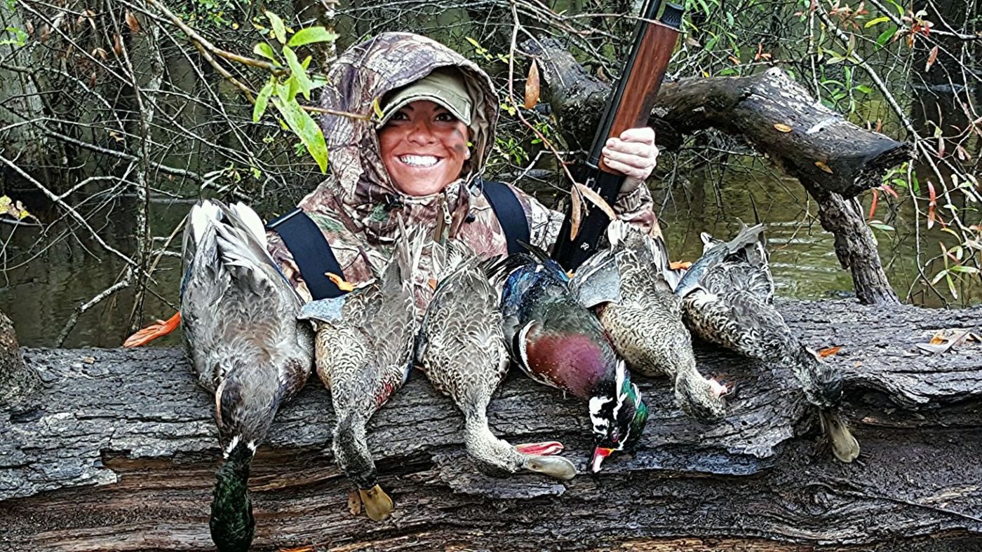 Duck hunter with her harvest at the BigWoods flooded timber