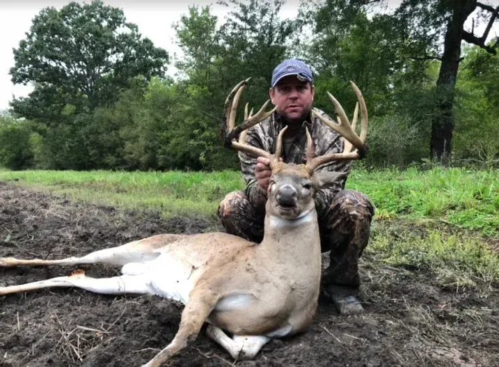 Hunter with a trophy whitetail buck at The BigWoods in East Texas